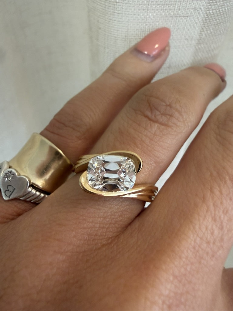 ERTE RING worn on the hand, 18k yellow gold with an elongated cushion cut lab grown diamond