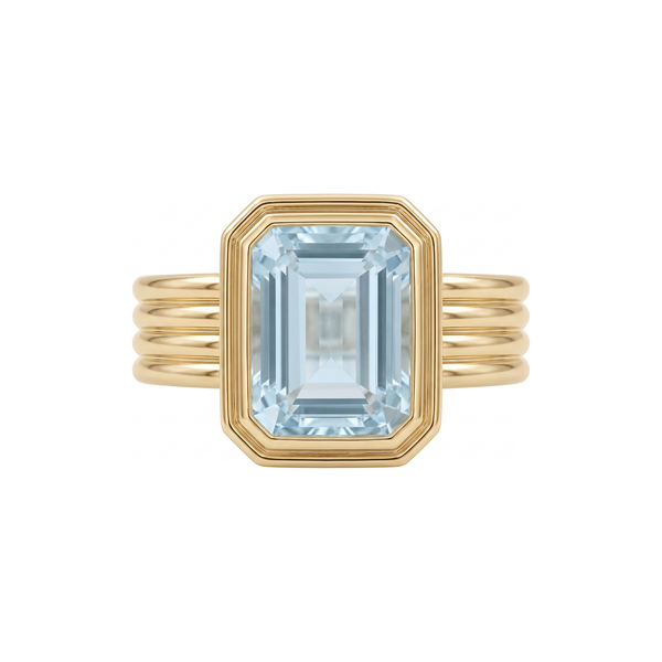 Rebecca Ring in 9k yellow gold, emerald cut blue topaz bezel set on a fluted band