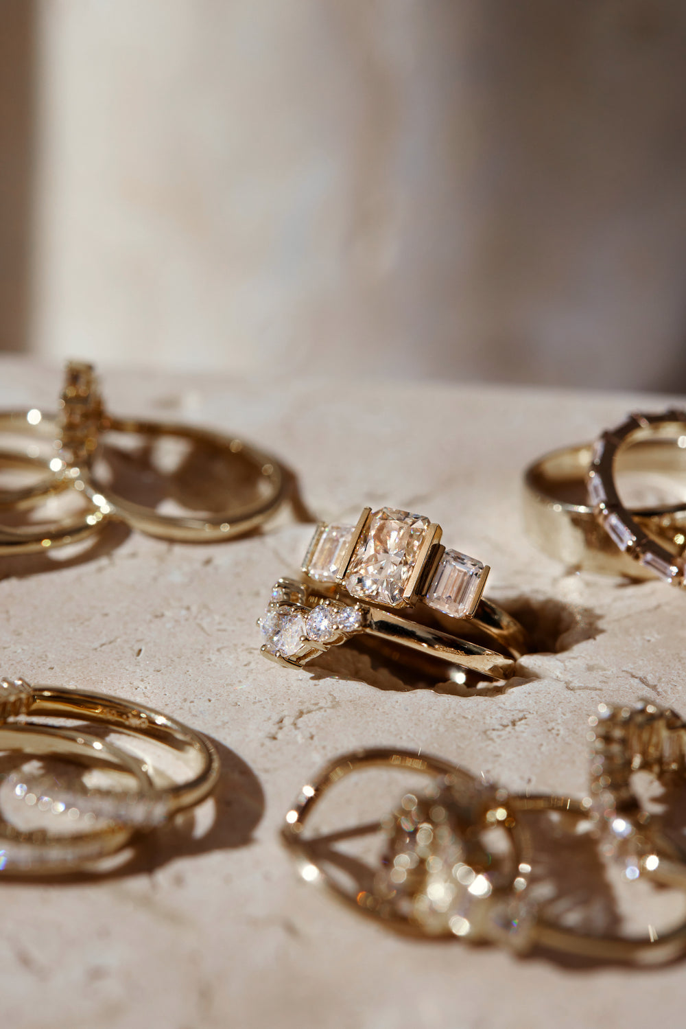 A gold signet ring resting on a spoon on a white plate.