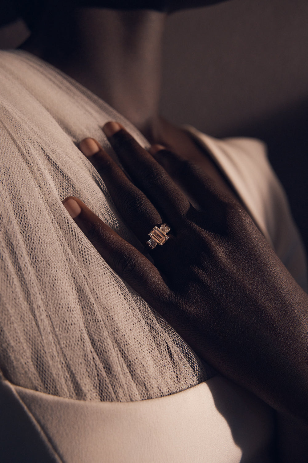 A White November ring worn on the hand in daylight.