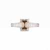 Empire Ring front on with champagne emerald cut centre diamond in 18k white gold with channel-set baguette diamond shoulders